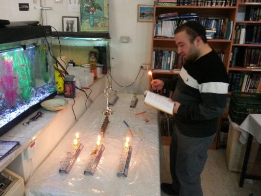 Our "lone soldiers" and guests celebrating Hanukkah