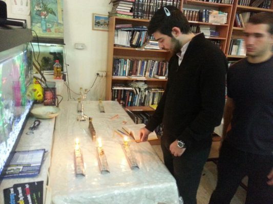 Our "lone soldiers" and guests celebrating Hanukkah