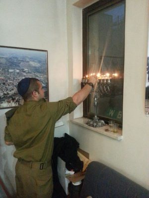 Our "lone soldiers" and guests celebrating Hanukkah