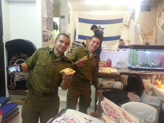 Our "lone soldiers" and guests celebrating Hanukkah