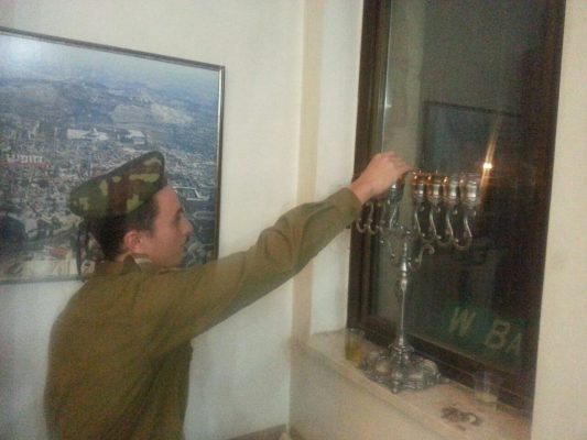 Our "lone soldiers" and guests celebrating Hanukkah
